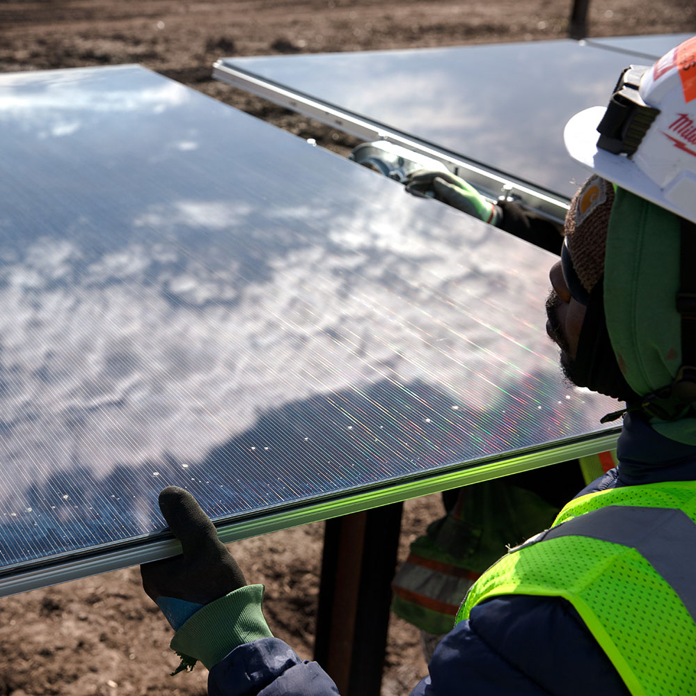 working installing a solar panel